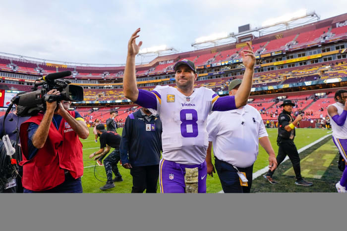 Kirk Cousins smiles and waves to the crowd as he leaves FedEx Field